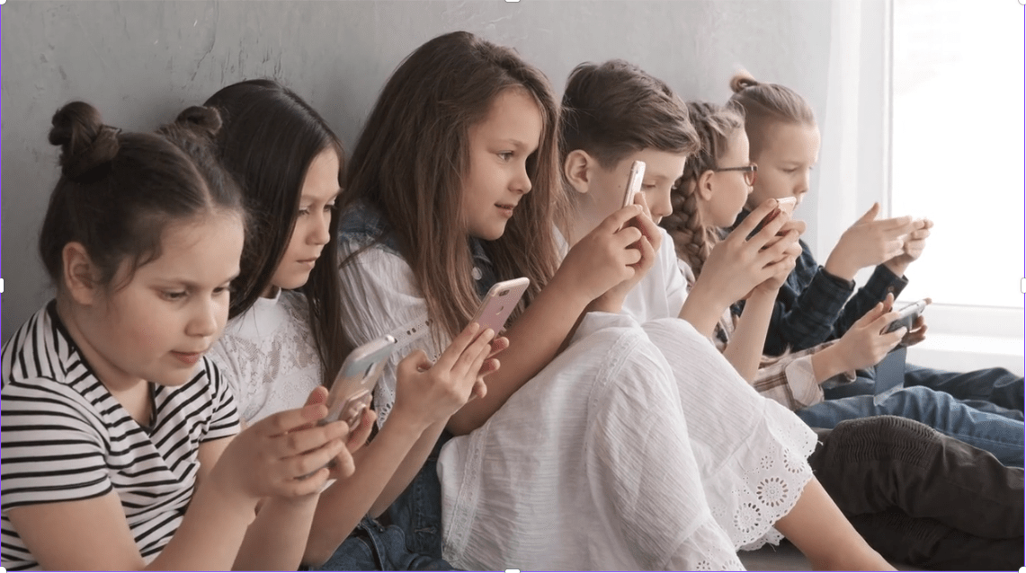 Children concentrating on mobiles